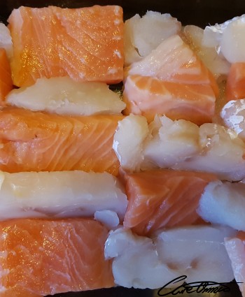 Salmon and cod pieces mixed on a tray