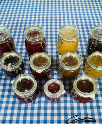 Several different preserves of berries on a table