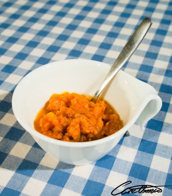 A cup of raw stirred cloudberries
