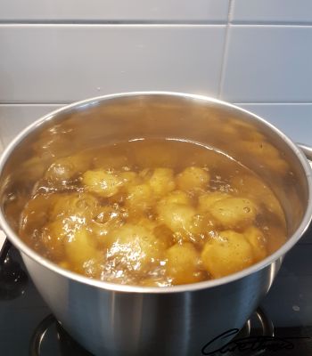 Boiling potatoes on a stove