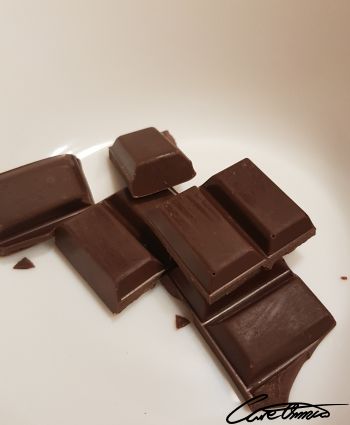 Dark chocolate in pieces on a plate 